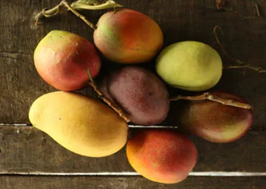 mangoes on wooden table