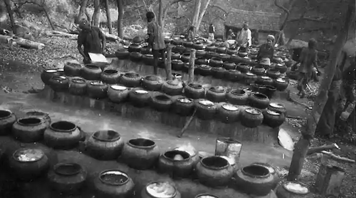 farmer cooking in pots